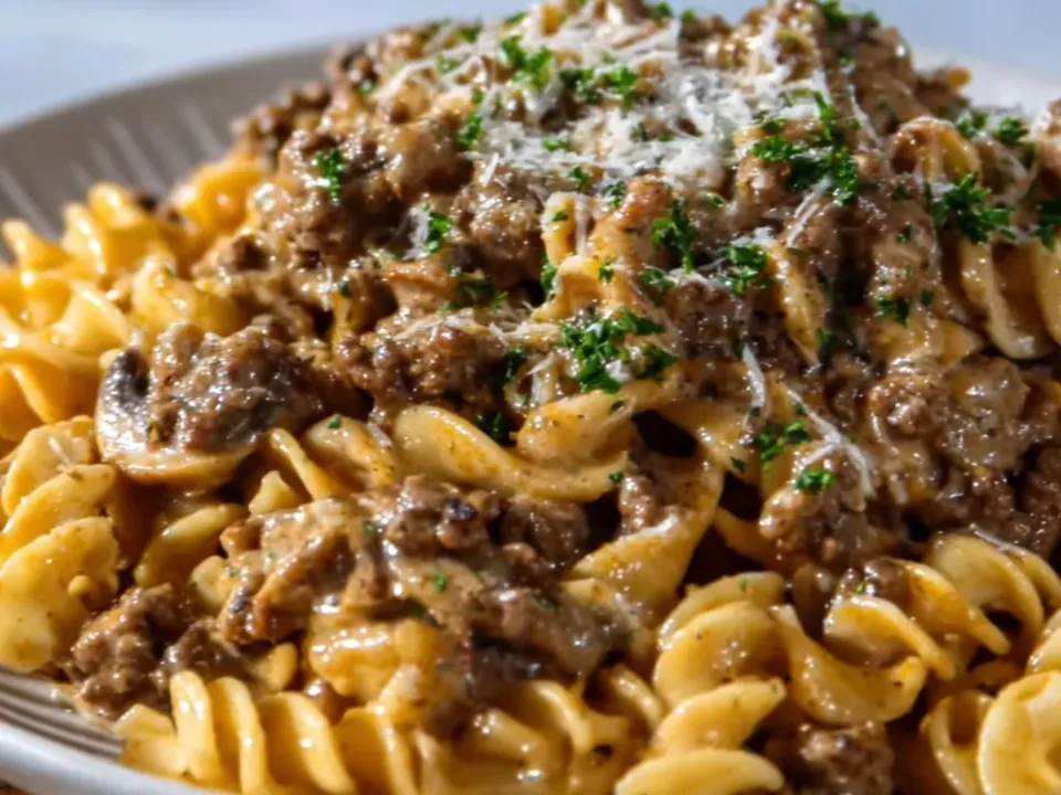 Ground beef and sliced mushrooms in a pale creamy sauce with wide egg noodles, grated cheese and chopped parsley