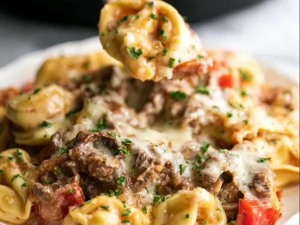 Cheese tortellini with shaved steak, sliced red pepper and melted provolone, finished with chopped parsley